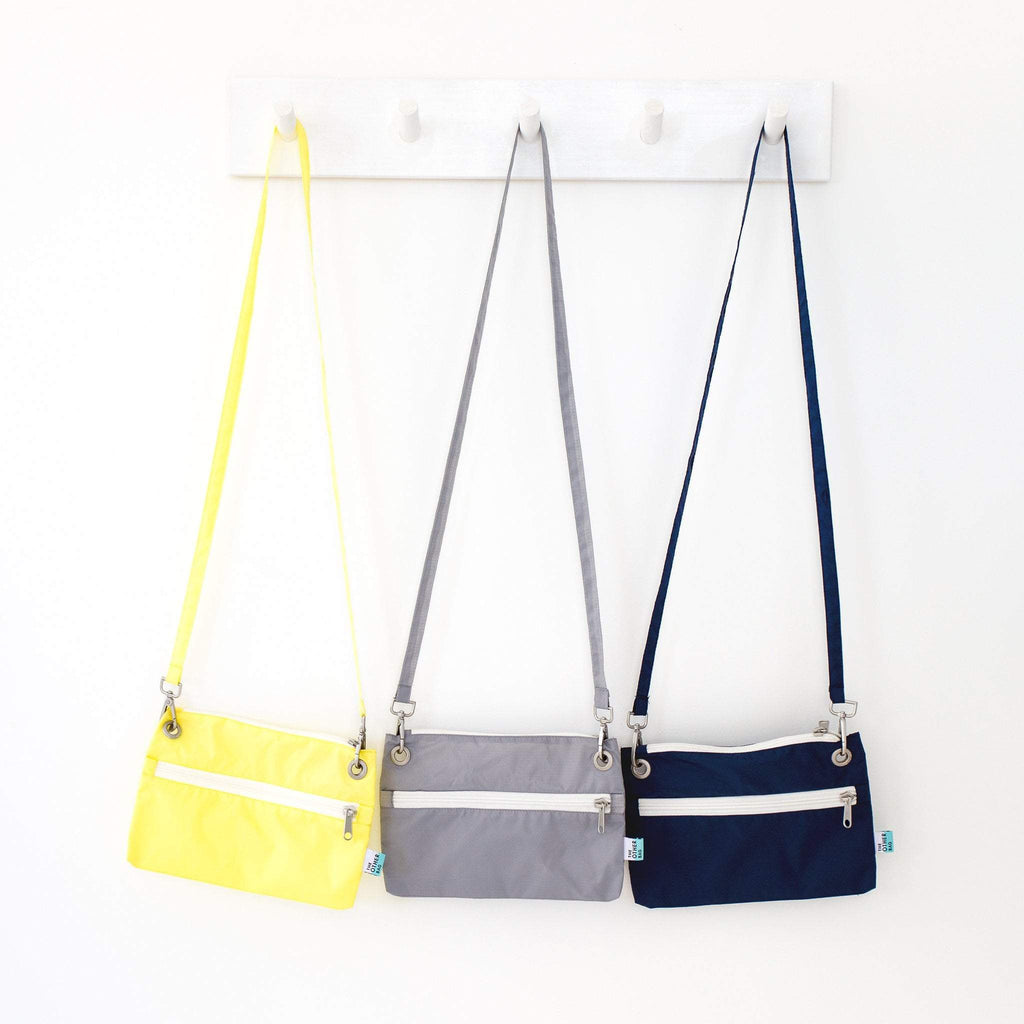 Recycled zip pouches hanging various colours