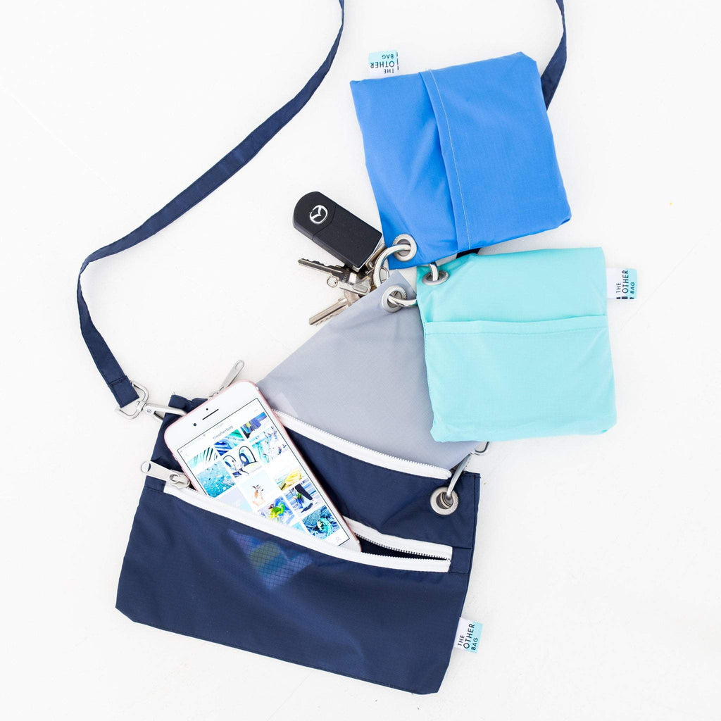 Navy recycled zip pouch and bundle of recycled foldable tote bags 