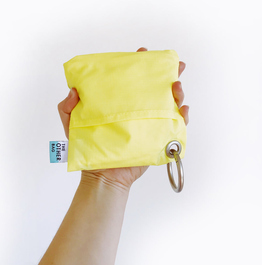 Recycled Econyl yellow and grey foldable tote bag in pouch